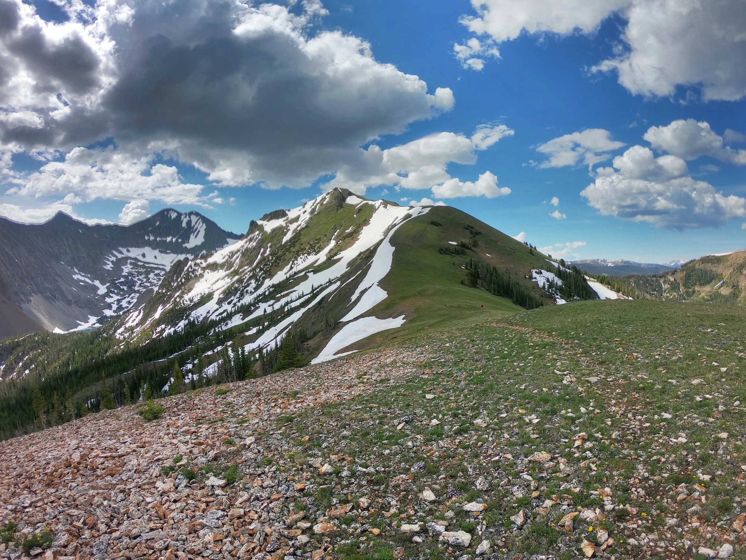 An open mountain ridgeline beneath a blue sky